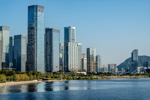 Dense cluster of futuristic skyscrapers with varied facades rising against bright daytime sky showcasing modern architectural diversity